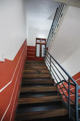 a staircase in a building with red and white walls at Hotel Diamond Castle in Manjeri