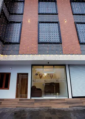 two different views of a building with a window at Hotel Diamond Castle in Manjeri