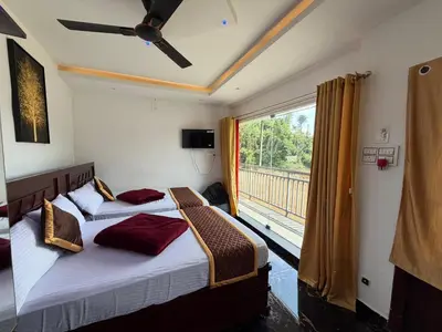 two beds in a room with a large window at Glasshouse Retreat by The Jungle stay groups in Vālpārai