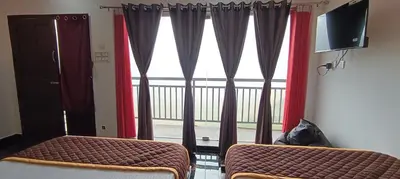 a room with a window with curtains and a bed and a television at Glasshouse Retreat by The Jungle stay groups in Vālpārai