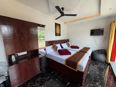 a bedroom with two beds and a ceiling fan at Glasshouse Retreat by The Jungle stay groups in Vālpārai