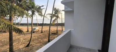 a room with a view of the beach and palm trees at Sea Breeze Cherai Homestay in Pallipuram