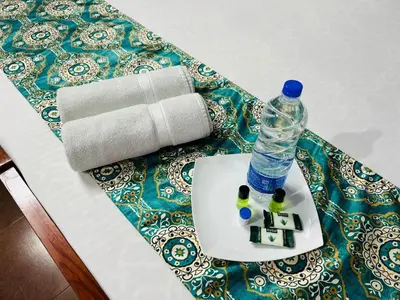 a bottle of water sitting on top of a table at ERA Heritage Inn in Kozhikode