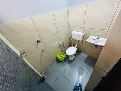 a bathroom with a toilet and a sink at ERA Heritage Inn in Kozhikode
