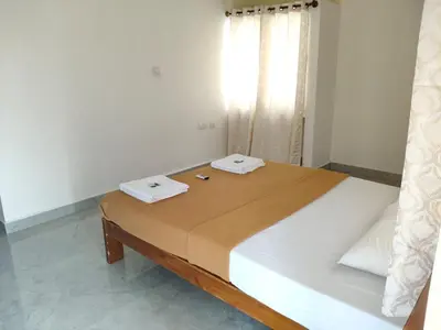 a bedroom with a large bed with two phones on it at Temple Bells in Mysore