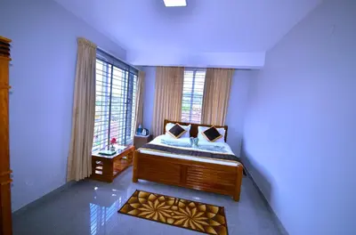 a bedroom with a bed and a large window at Cute Corner Homestay,Ooty in Ooty
