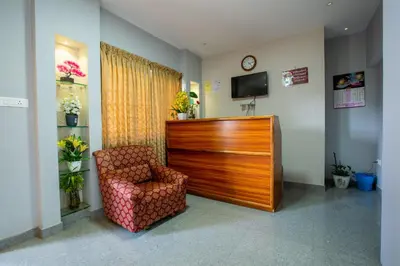 a waiting room with a chair and a dresser at Cute Corner Homestay,Ooty in Ooty