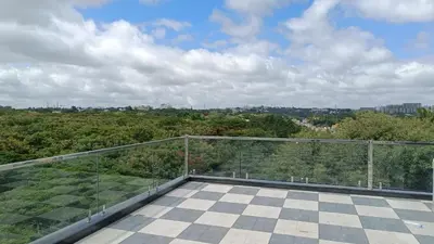 a balcony with a view of the trees at Eve Service apartment in Mysore