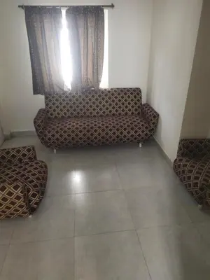 a living room with a couch and a window at Ooty mountain Cottage in Ooty
