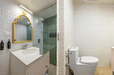 a bathroom with a sink and a toilet and a mirror at Tiverton Bungalow in Ooty