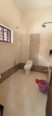 a bathroom with a toilet and a sink at Aura Villa in Kozhikode