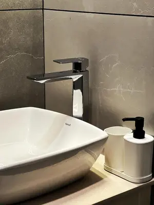 a bathroom sink with a faucet on a counter at Green Leaves The Countryside Inn in Ooty