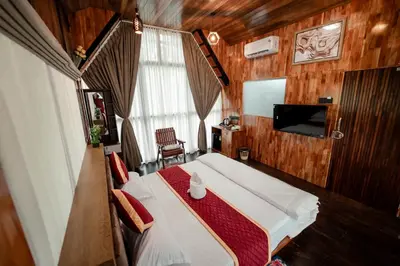 a small room with a bed and a television at Wayanad Vista Palm View Homes in Padinjarathara