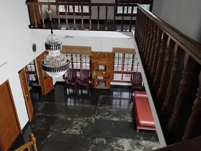 an overhead view of a dining room with chairs and a staircase at Vasantham Home Stay in Satyamangalam