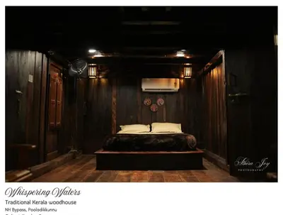 a bedroom with a bed in a wooden wall at whispering waters in Kozhikode