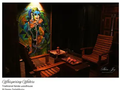 a room with two chairs and a painting on the wall at whispering waters in Kozhikode