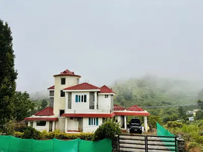 a house on top of a hill with a fence at BR Villa in Kodaikānāl