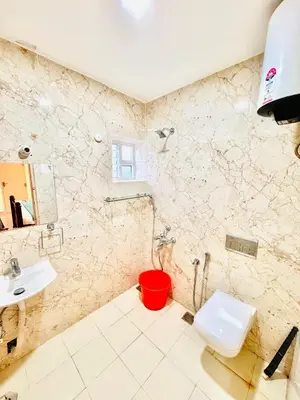 a bathroom with a toilet and a sink at BR Villa in Kodaikānāl