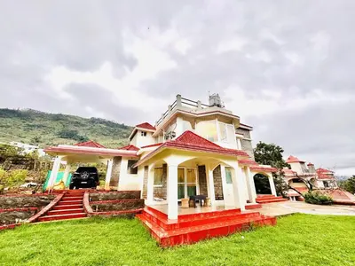 a white house with a red roof at BR Villa in Kodaikānāl