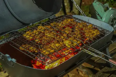 a bunch of food is cooking on a grill at Valley View by Xploreindo in Pandalūr