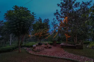 a park with a string of lights hanging from trees at Valley View by Xploreindo in Pandalūr