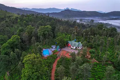 an aerial view of a house in the middle of a forest at Valley View by Xploreindo in Pandalūr