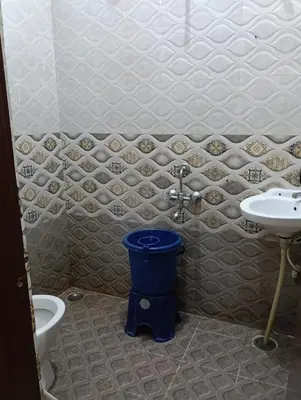a bathroom with a toilet and a sink at MM comforts in Mysore