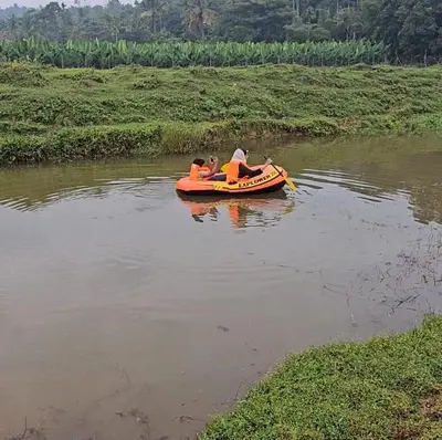two people are riding on a raft in a river at Diamond Villas Wayanad Entire Villa booking in Mananthavady