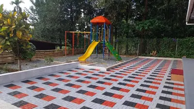 a playground with a slide in a park at Diamond Villas Wayanad Entire Villa booking in Mananthavady