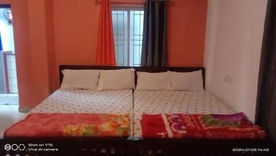 a bed with two pillows and a comforter at Dam Valley Home Stay Resort in Parambikolam