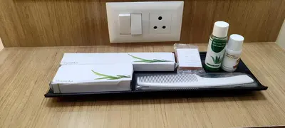 a black tray with two white towels and a toothbrush at Sree Nandhanam Apartment's in Guruvāyūr