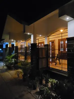 a building with bars on the windows at night at Akalapuzha Homestay in Kozhikode