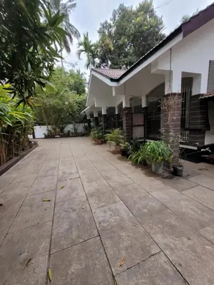 an empty courtyard of a house with plants at Akalapuzha Homestay in Kozhikode