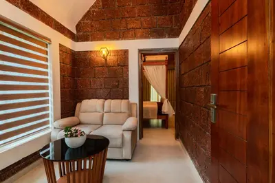 a living room with a couch and a table at Misty Forest Resort Wayanad in Wayanad