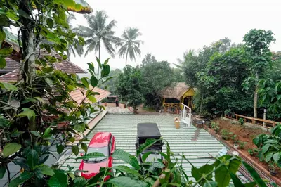 a group of chairs sitting on the steps of a house at Wayanad Vista Family Bungalow in Padinjarathara
