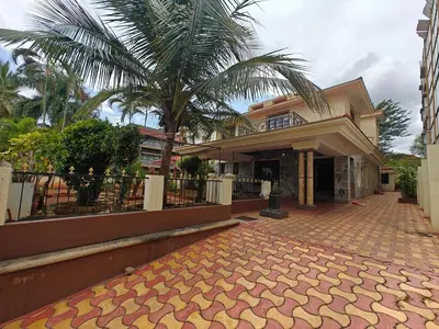 a house with a palm tree in front of it at 6bhk Luxury Villa in Mysore