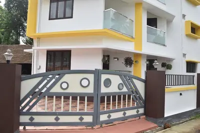 a house with a gate and a balcony at 2BHK Flat At Chalakudy Town Konuparamban Residence A1 in Kizhake Chālakudi