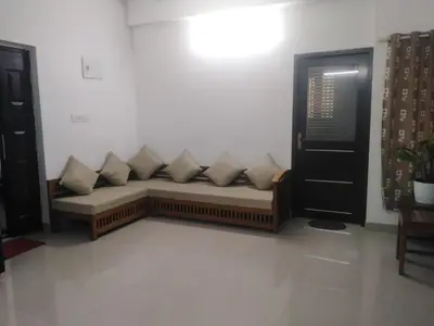 a couch with pillows sitting in a room at 2BHK Flat At Chalakudy Town Konuparamban Residence A1 in Kizhake Chālakudi