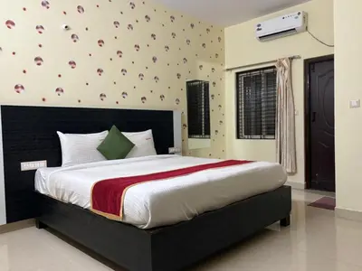a bedroom with a large bed in a room at Avini Stay in Mysore
