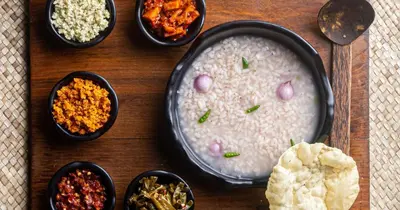 a table with a bowl of rice and bowls of food at Farmville Riverside in Kakkayam