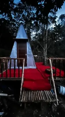 a playground with a tent and a red blanket at Alpine Mud house Kanthalloor in Kanthalloor