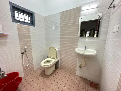 a bathroom with a toilet and a sink at The Chill Spot in Karuvapadna