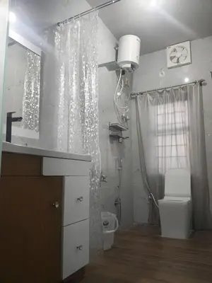 a bathroom with a toilet and a sink and a shower at Coorg Ashiyana in Kushālnagar