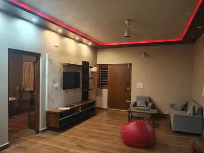a living room with a red light on the ceiling at Coorg Ashiyana in Kushālnagar