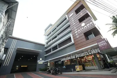 a building with a motorcycle parked in front of it at Atland Residency in Calicut