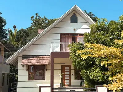 a white house with a red roof at Chakkantharas Pool Villas in Athirappilly