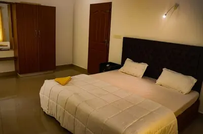 a bedroom with a large bed with two pillows at Chakkantharas Pool Villas in Athirappilly