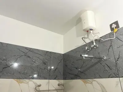 a bathroom with a shower with a glass wall at Chakkantharas Premium Villa in Athirappilly