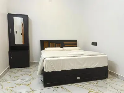 a bedroom with a bed with a mirror and a dresser at Chakkantharas Premium Villa in Athirappilly