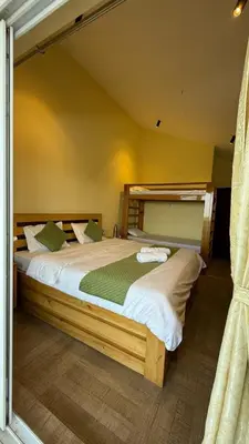 a bedroom with a large bed in a room at Longwood Resorts in Kotagiri